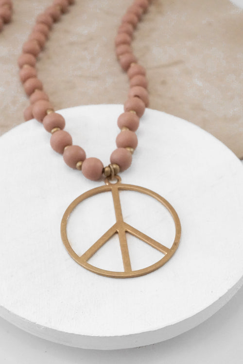 Long Wood Bead Necklace with golden peace sign pendant - Pink