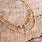 Layered Gold Chain Necklace with Cylinder and Crystal Accents