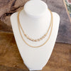 Layered Gold Chain Necklace with Cylinder and Crystal Accents