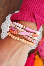 Pink stack of 5 clay and wood beads bracelets in pinks, white and peach