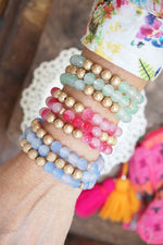 Worn gold tone and glass beads bracelets stack Hot Pink Blue Green