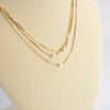 Multi chain short dainty necklace with 3 small pearls in gold tone