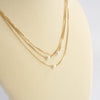 Multi chain short dainty necklace with 3 small pearls in gold tone