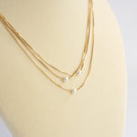 Multi chain short dainty necklace with 3 small pearls in gold tone