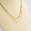 Multi chain short dainty necklace with 3 small pearls in gold tone