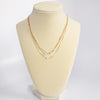 Multi chain short dainty necklace with 3 small pearls in gold tone