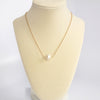 Short dainty necklace with a Pearl in gold tone