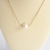 Short dainty necklace with a Pearl in gold tone