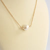 Short dainty necklace with a Pearl in gold tone