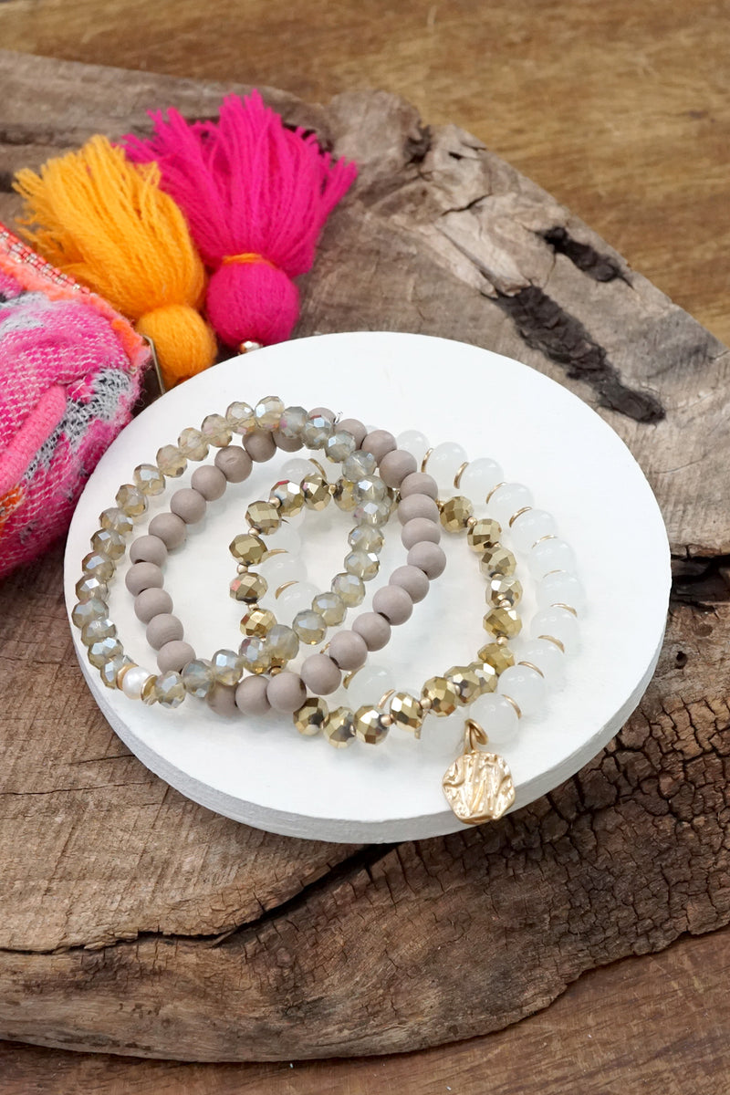 Beaded Bracelets set in White and Gray with a coin charm
