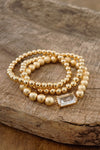 Gold tone multi size ball beaded bracelet stack with a Crystal