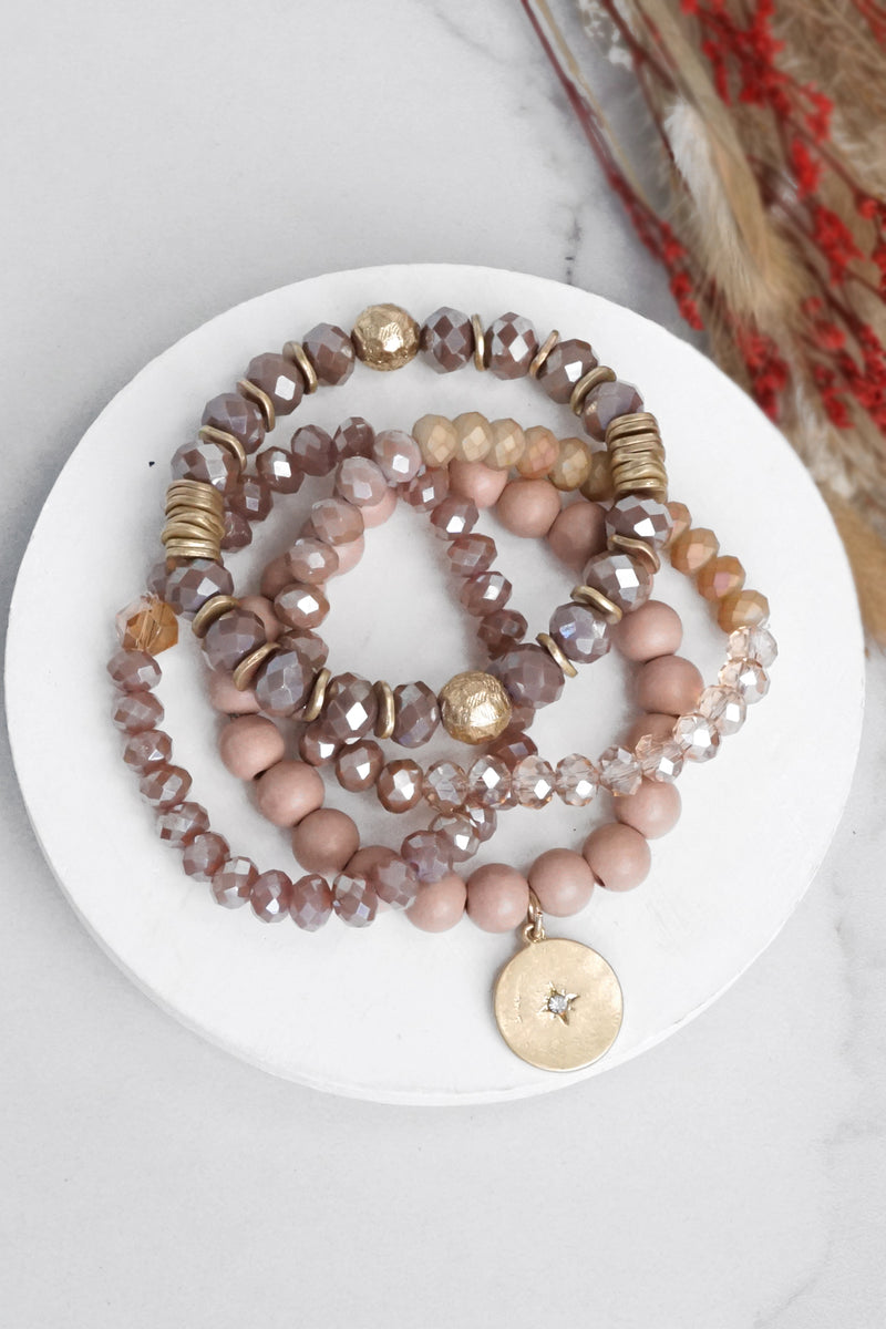 Beaded bracelets set in Blush Pink with a coin charm