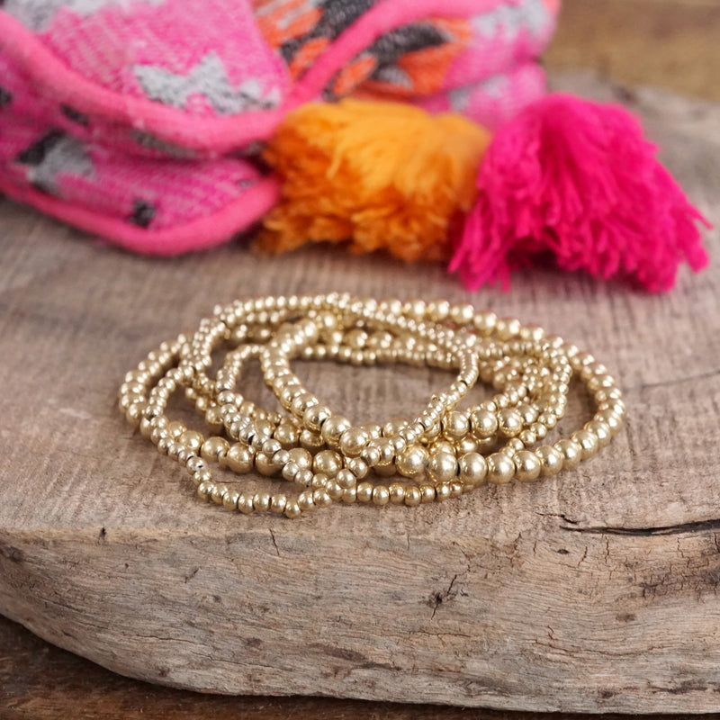 Worn Gold tone multi size beaded bracelet stack of 6 bracelets