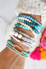 Blue stack of 5 clay and wood beads bracelets in blues and white