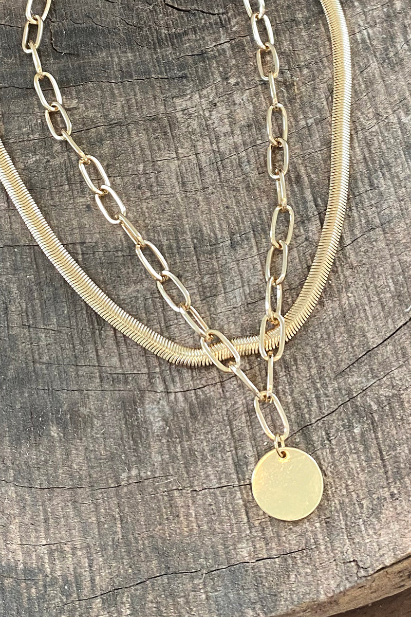 Layered gold tone short necklace set with a coin pendant
