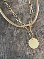 Layered gold tone short necklace set with a coin pendant