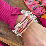Pink stack of 5 clay and wood beads bracelets in pinks, white and peach